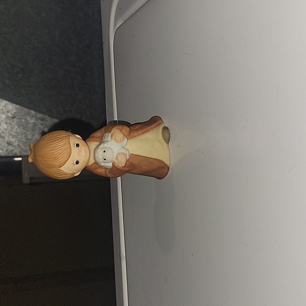 Child Holding Lamb Figurine